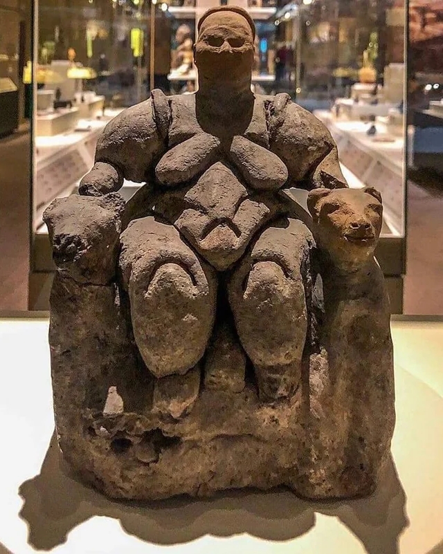 The Seated Woman of Catalhoyuk (Catal Hoyuk), a 8000 year-old Neolithic baked-clay nude female form figurine, seated between feline-headed arm-rests.jpg