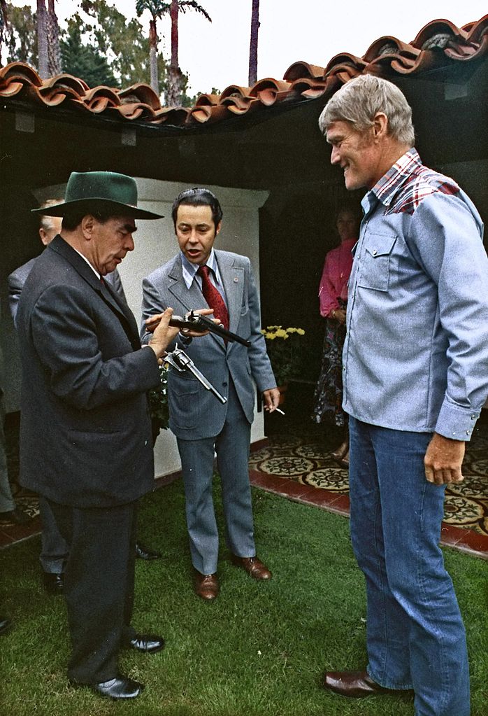 General Secretary of the Soviet Communist Party Leonid Brezhnev and interpreter Viktor Sukhodrev meet Chuck Connors, 1973.jpg