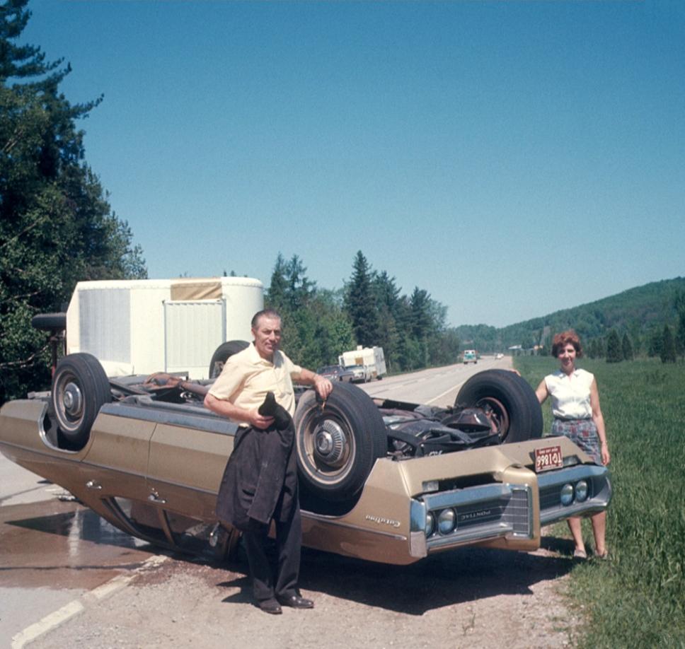 A vacationing couple pose with their Pontiac Catalina. 1969.jpeg