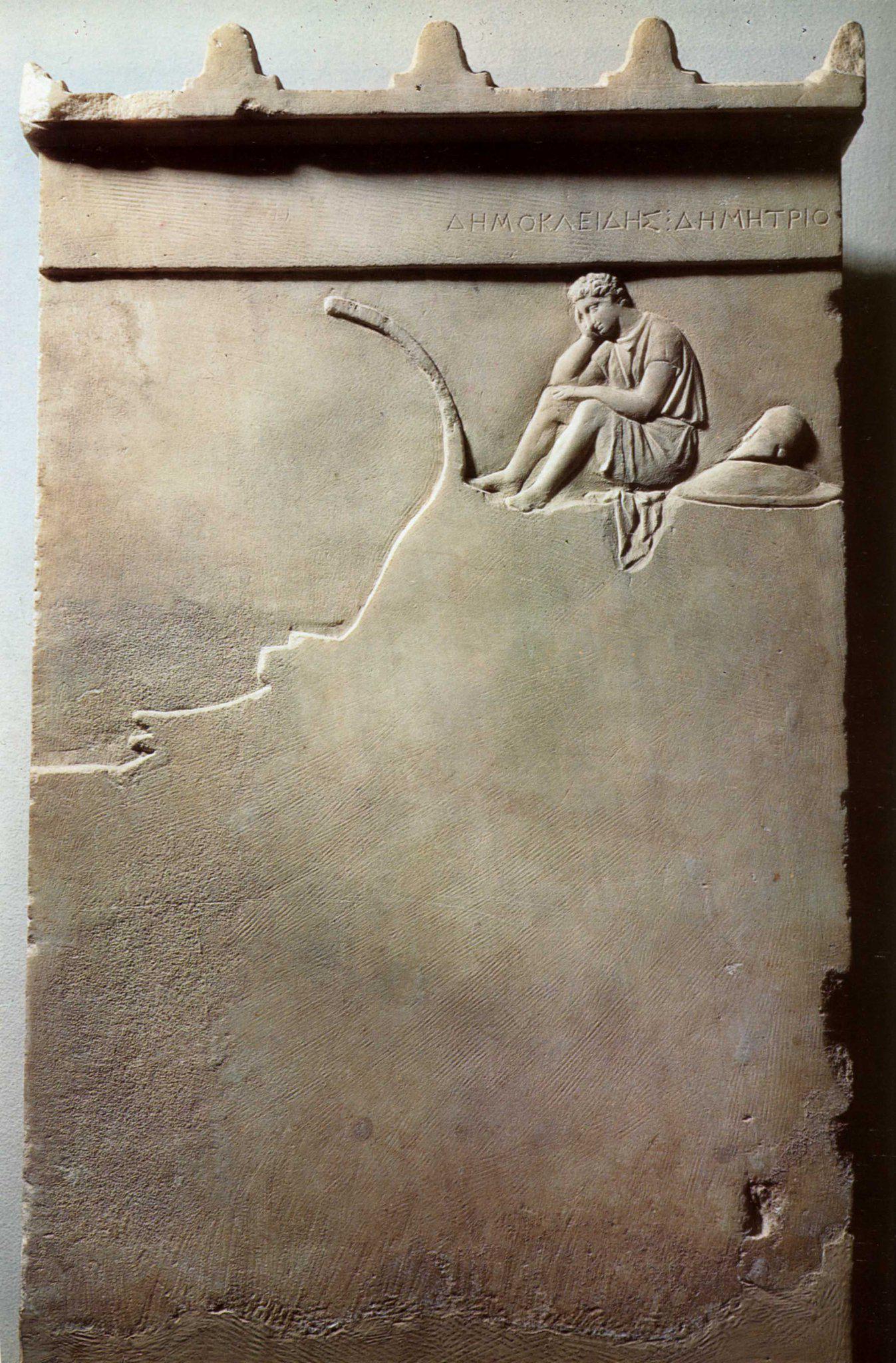 The Funerary Stela of Demokleides, a Greek hoplite who was killed in the naval battle of Corinth in 394 BCE. Demokleides is shown sitting on the prow of a trireme in a pensive position.jpeg