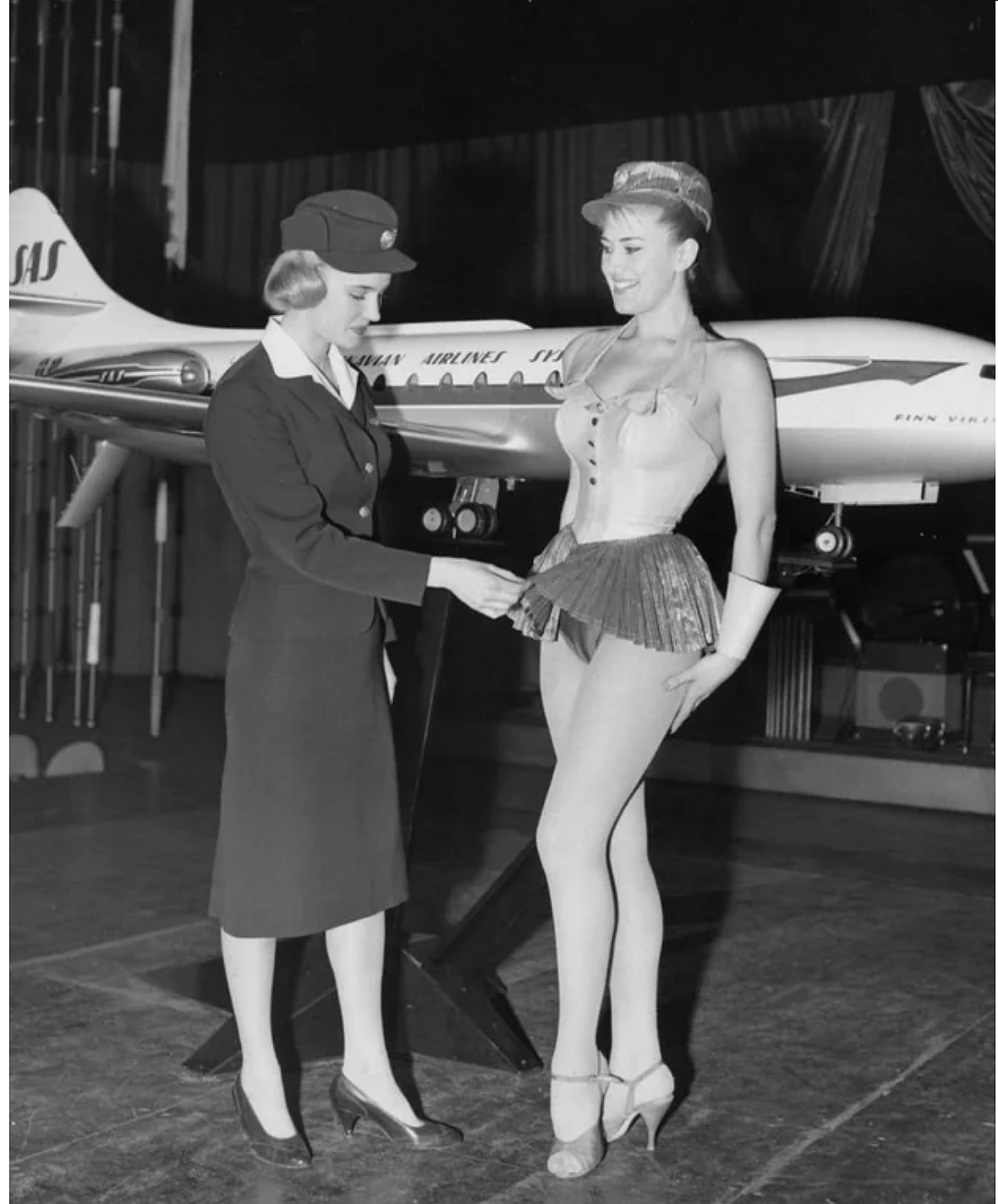 A Scandinavian Stewardess examines a new uniform proposal for Scandinavian Airlines in 1964. It was not approved..jpg