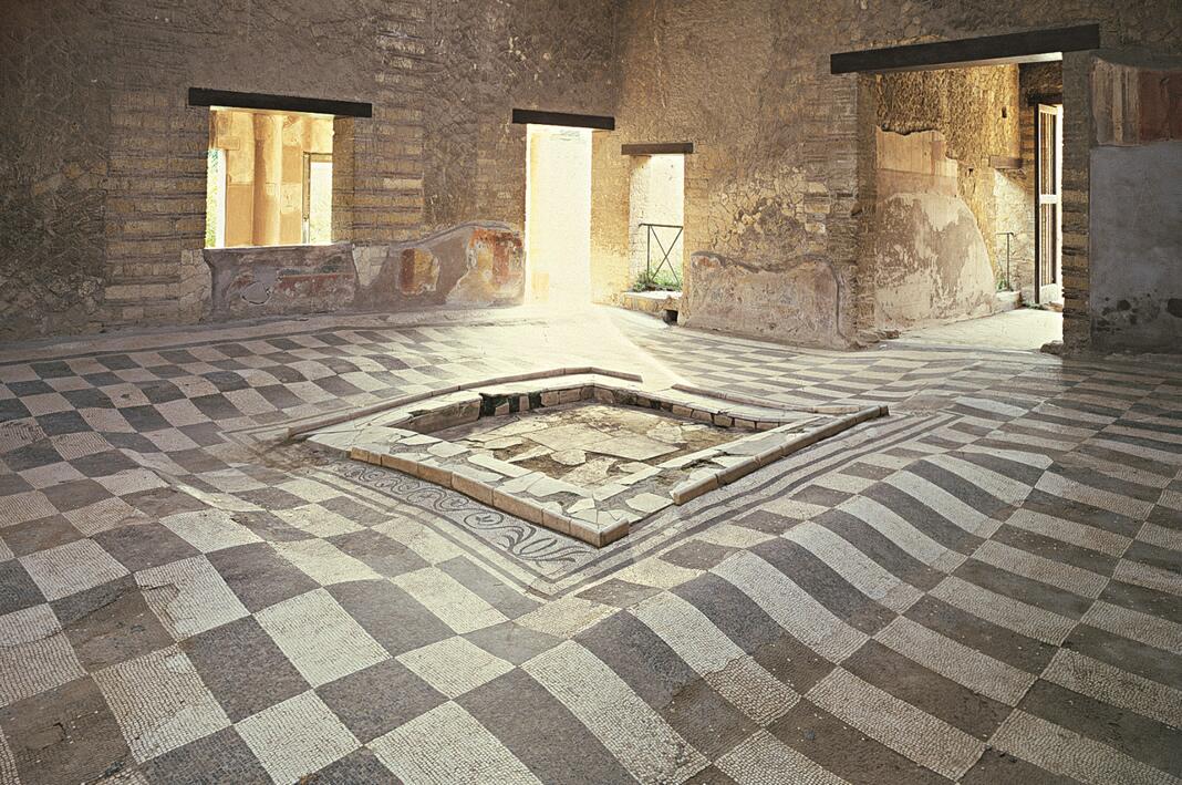 House of the Mosaic Atrium in Herculaneum, Italy, 1st century BCE. The undulation of the pavement is due to the yielding of the ground beneath the enormous weight of the eruptive mass.jpeg