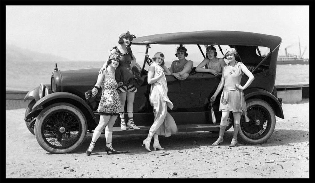 Flappers pose with a car in the 1920s.jpeg