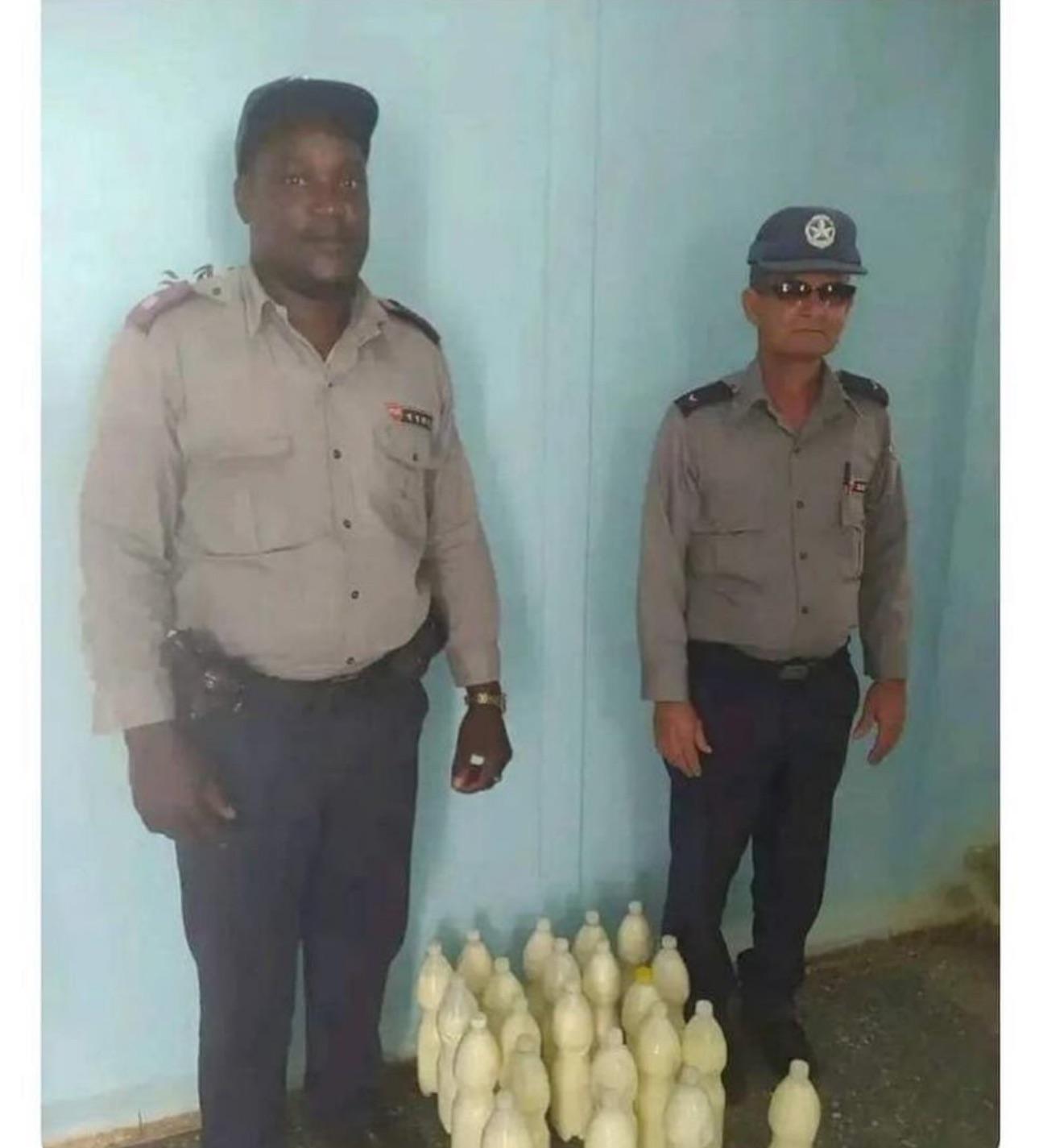 Cuban police pose with confiscated yogurt they took from cow farmers trying to sell it..jpeg