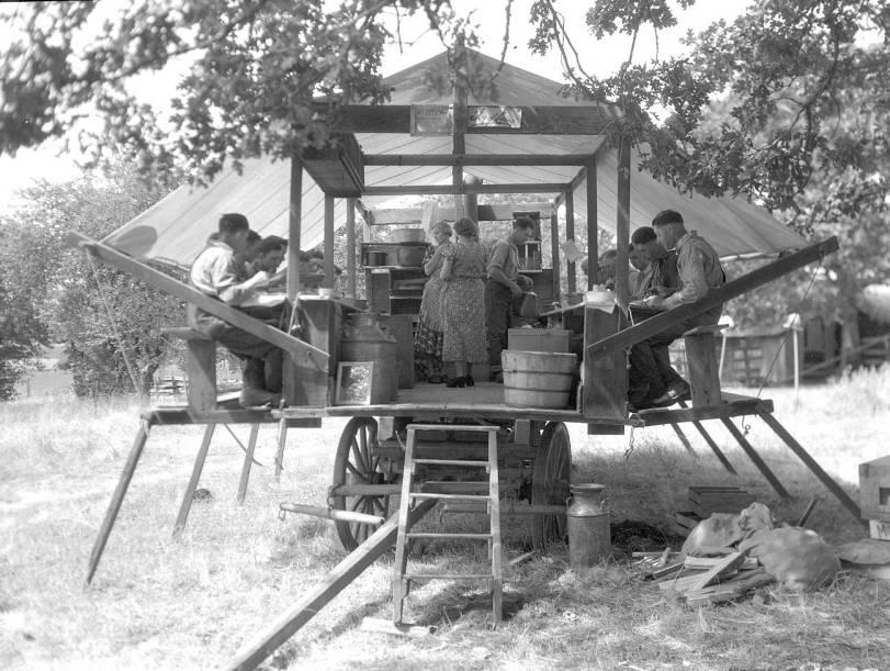 Farmworkers outside of Salem, Oregon eating in a chuckwagon in 1937.jpeg
