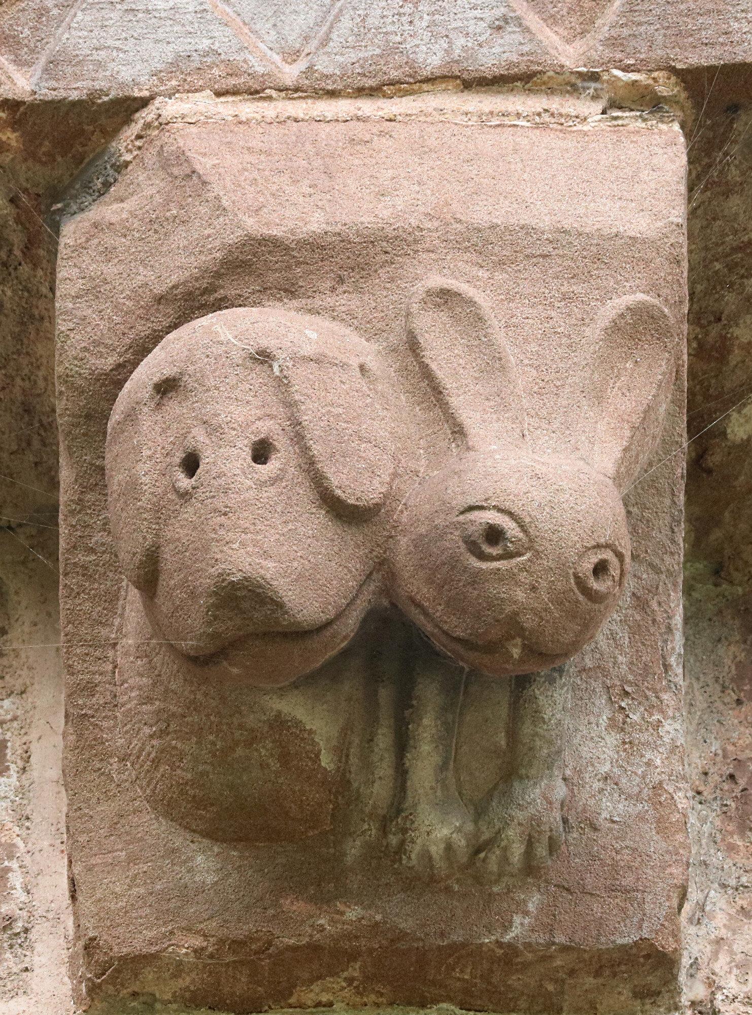 A 12th century CE carved corbel at the Church of St Mary and St David in Kilpeck, England, depicting a hound and hare.jpeg