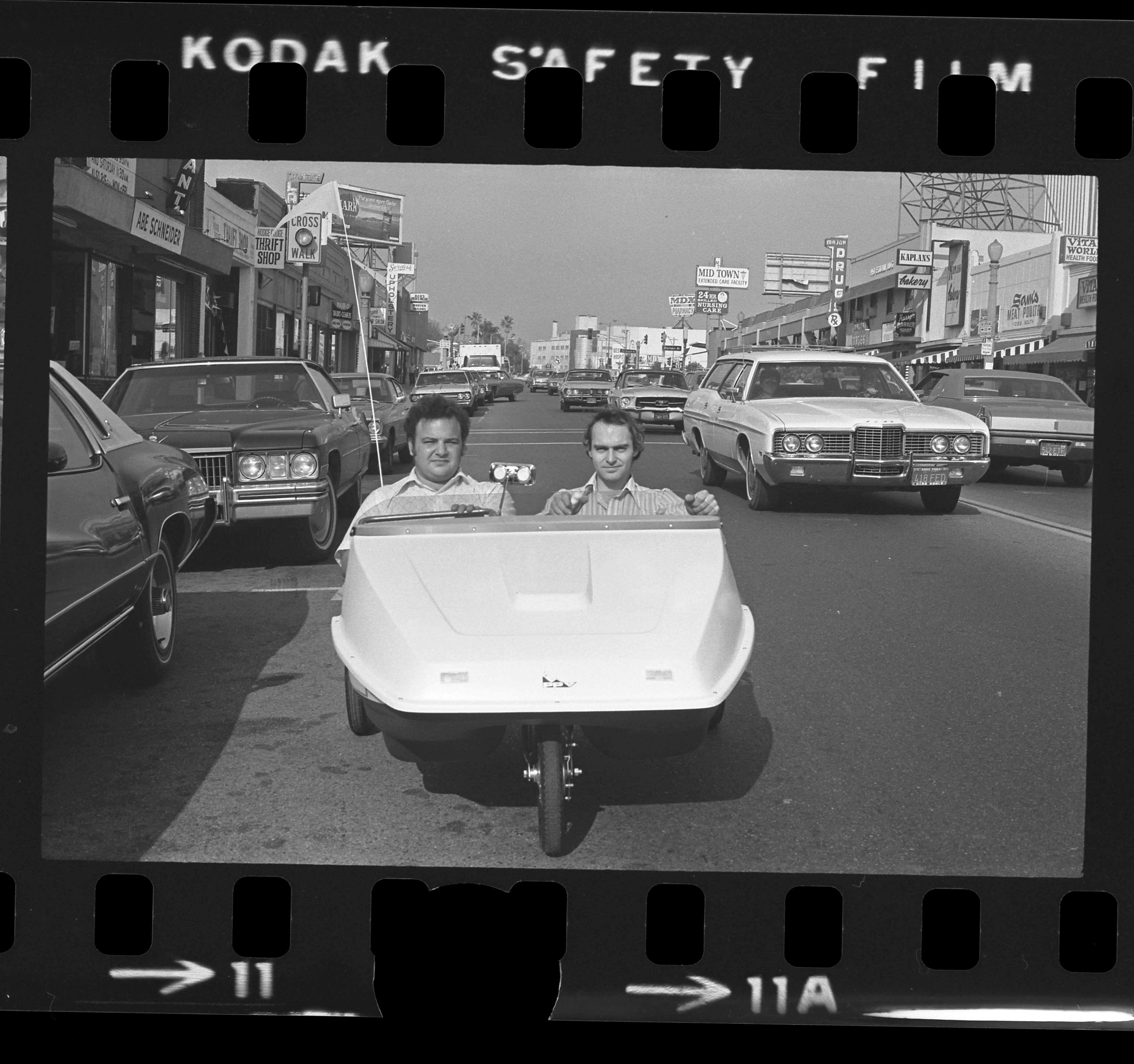 Steven Goldsmith and Rich Blum driving their 'People Powered Vehicle' pedal car down Fairfax Avenue in Los Angeles, California, 1973.jpeg