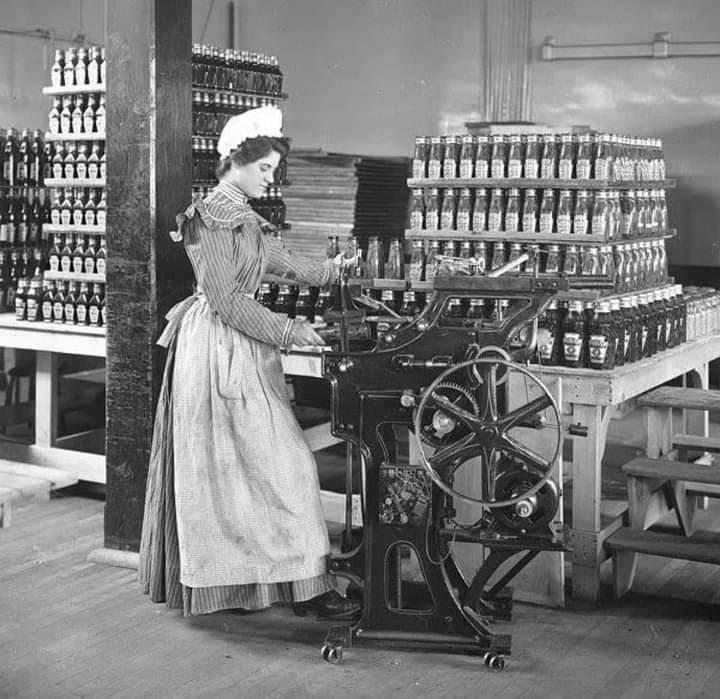 A woman bottling ketchup in a Heinz factory. Late 1890s.jpeg