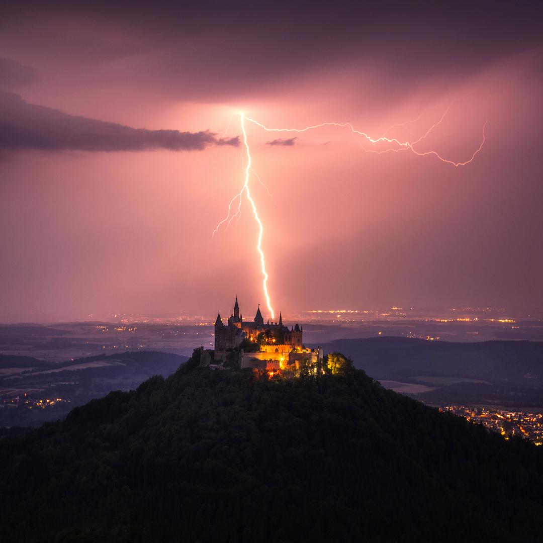 a lightning bolt striking behind Hohenzollern Castle in Germany.jpeg