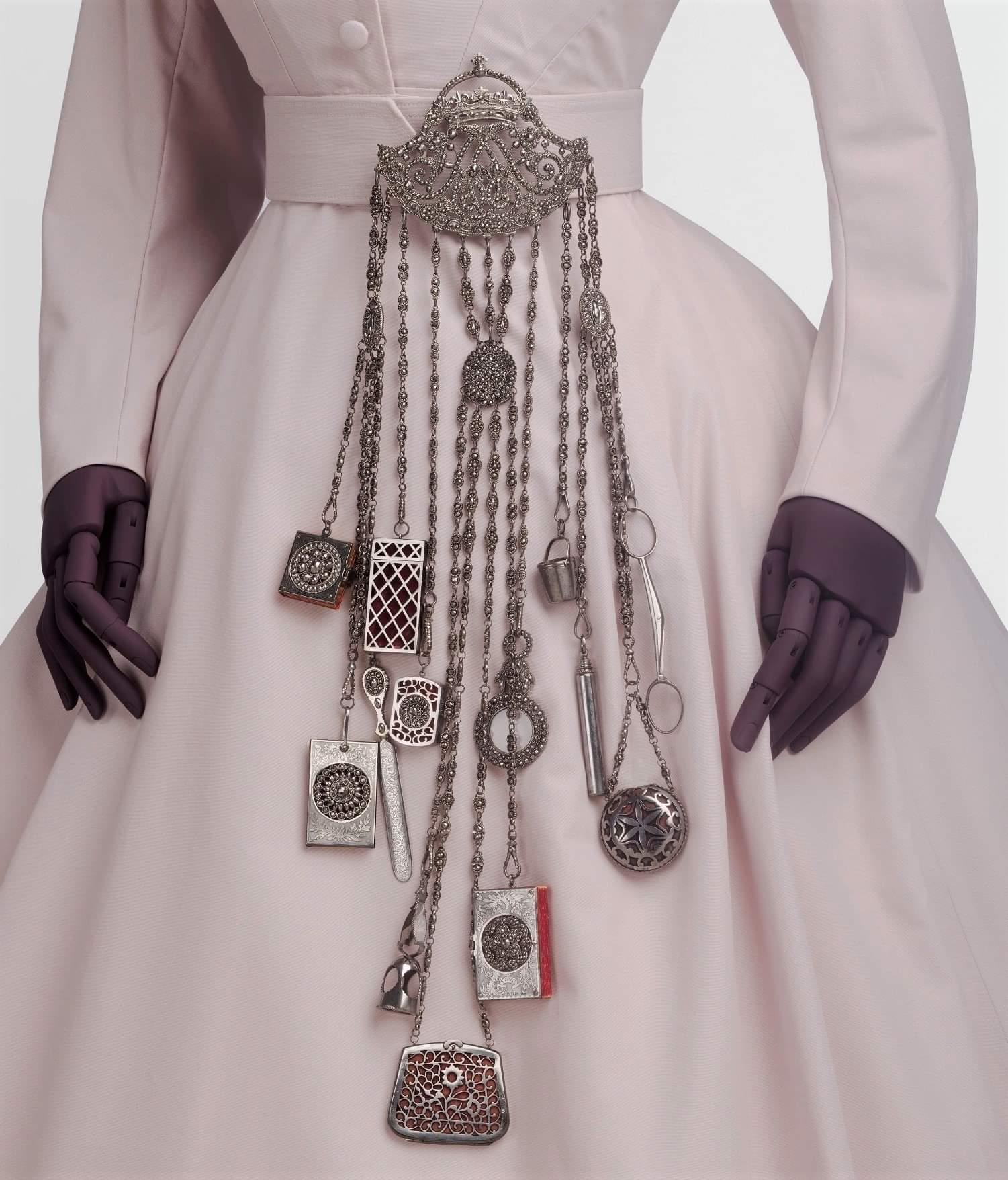 A chatelaine used by Alexandra, Princess of Wales. It comes with 13 accessories, including scissors, a scent bottle, a magnifying glass and a Notebook. Made in England, 1863-1885 CE.jpeg