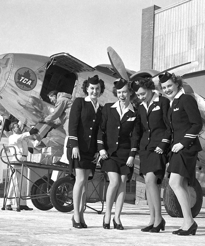 1949, Winnipeg, Canada. Trans-Canada Airlines flight attendants show off nylon stockings reintroduced to their uniforms following WWII.jpeg