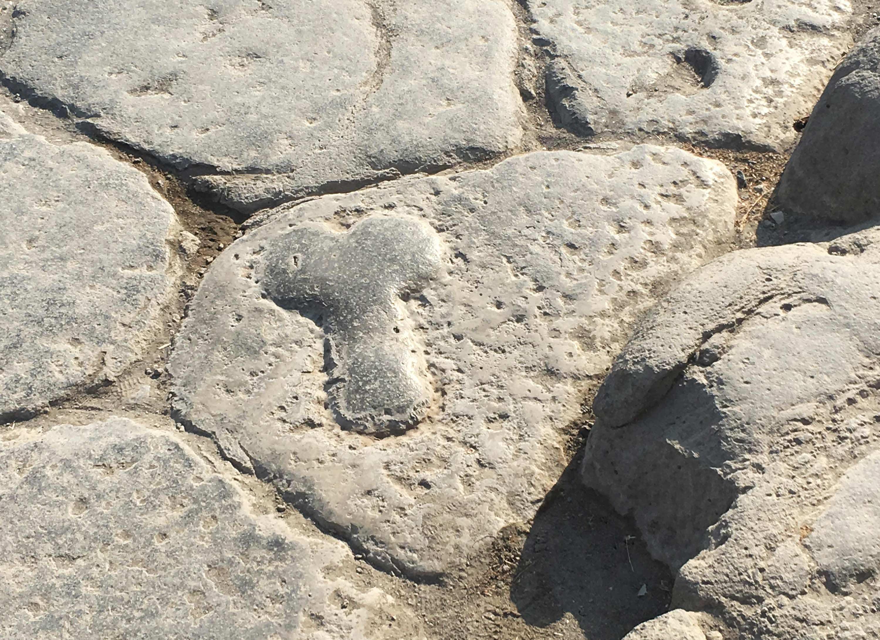 Carving in the road Pointing the Way to the Brothels in Pompeii AD 79.jpeg