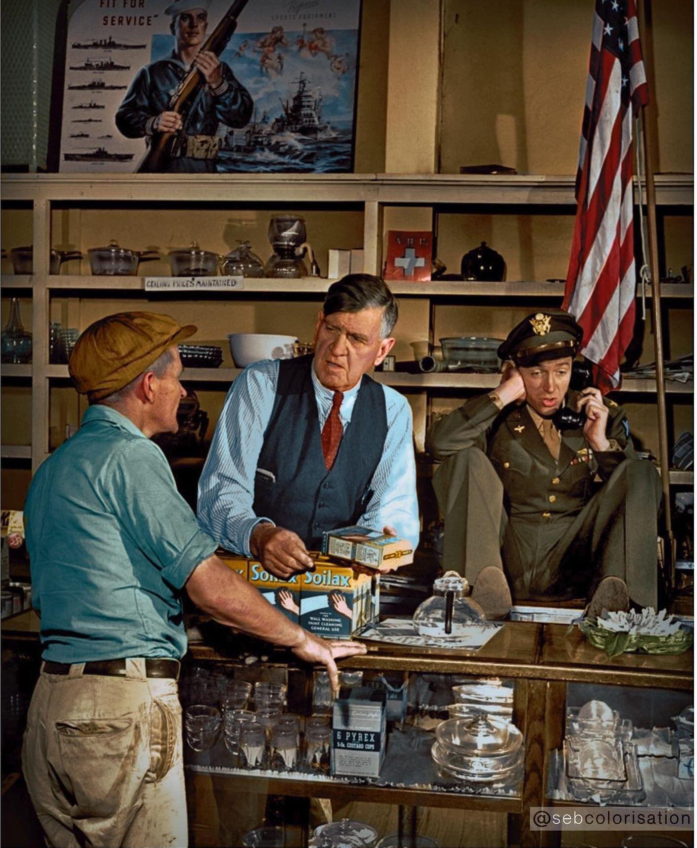 James Stewart on the phone as his father Alexander serves a customer at his family’s hardware store in Indiana, Pennsylvania. Photograph taken by Peter Stackpole in 1945.jpeg