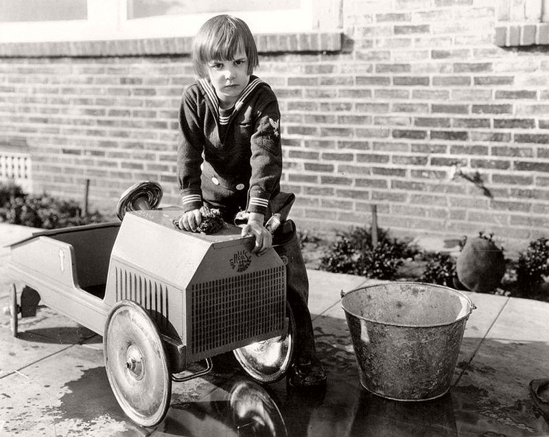 A young Jackie Coogan, who would grow up to become the first Uncle Fester, with his peddle car. 1920s.jpeg