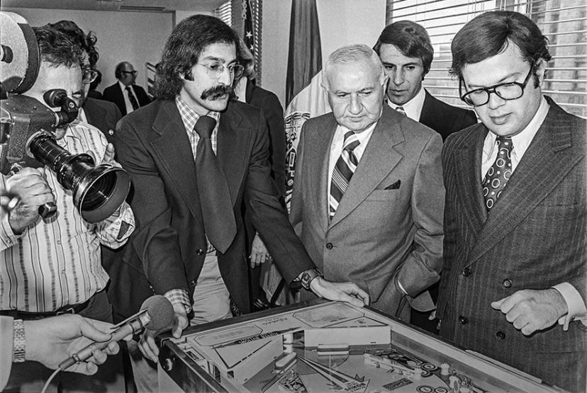 Roger Sharpe demonstrating to NYC council that pinball is a game of skill, not luck by calling a shot making it which lifts the ban of pinball saving it throughout the country. (1976).jpeg