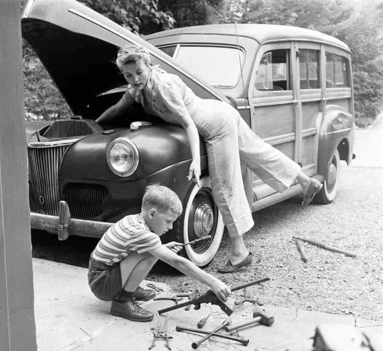With her husband at war, Mom works on the car, 1944.jpeg