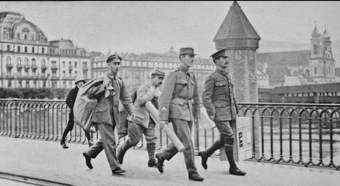 German, French and British soldier collect post, escorted by a Swiss soldier (front right).jpeg