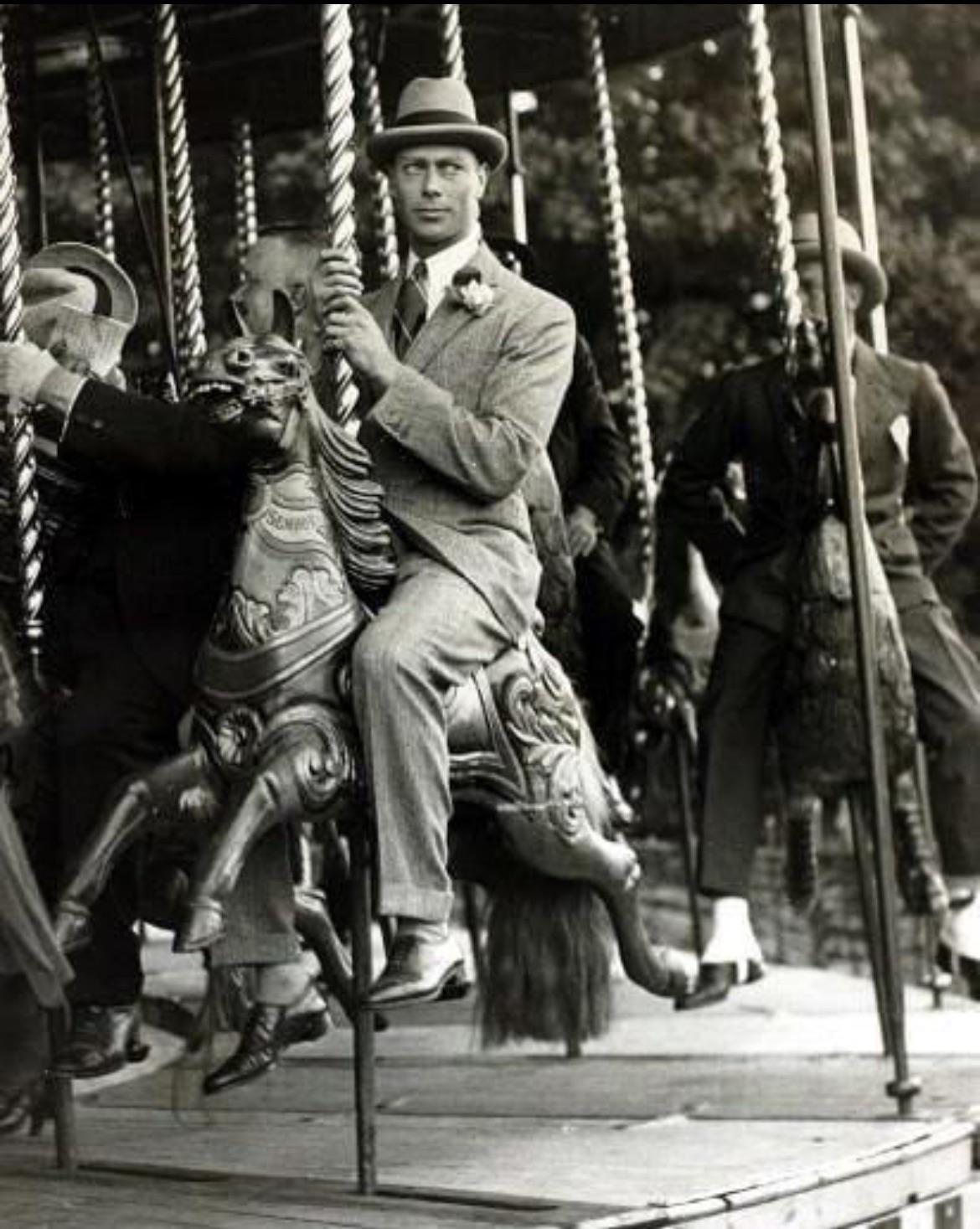 King George VI riding a merry-go-round at the Great Bookham fete - Surrey, England - June 1922.jpeg