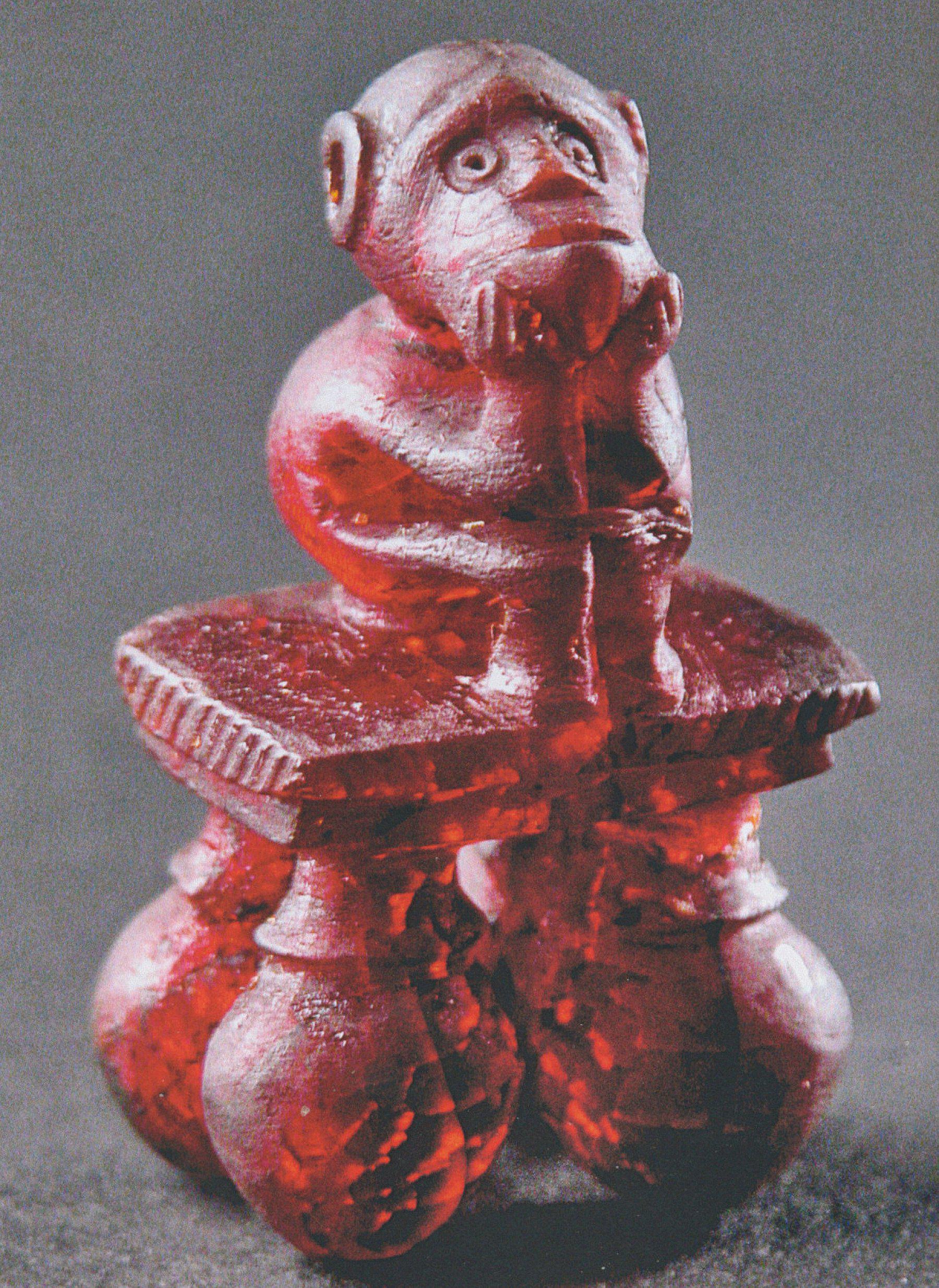 An Etruscan amber pendant in the shape of a crouching monkey. Height 4.7 cm, found in Vetulonia in Italy, dating late 8th-early 7th century BCE.jpeg