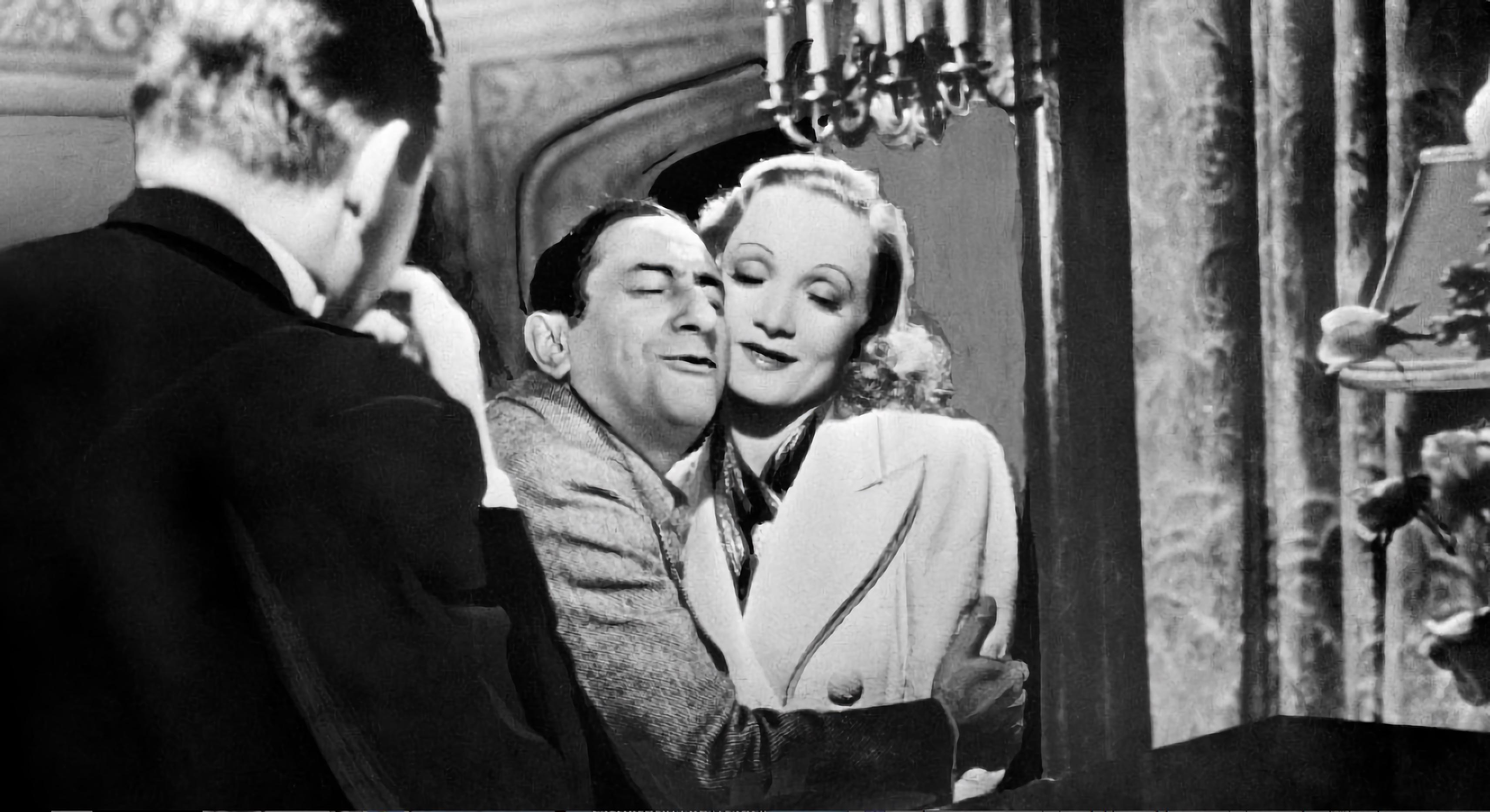 On the set of Angel, 1937. Director Ernst Lubitsch is showing Melvyn Douglas how to hug Marlene Dietrich.jpeg