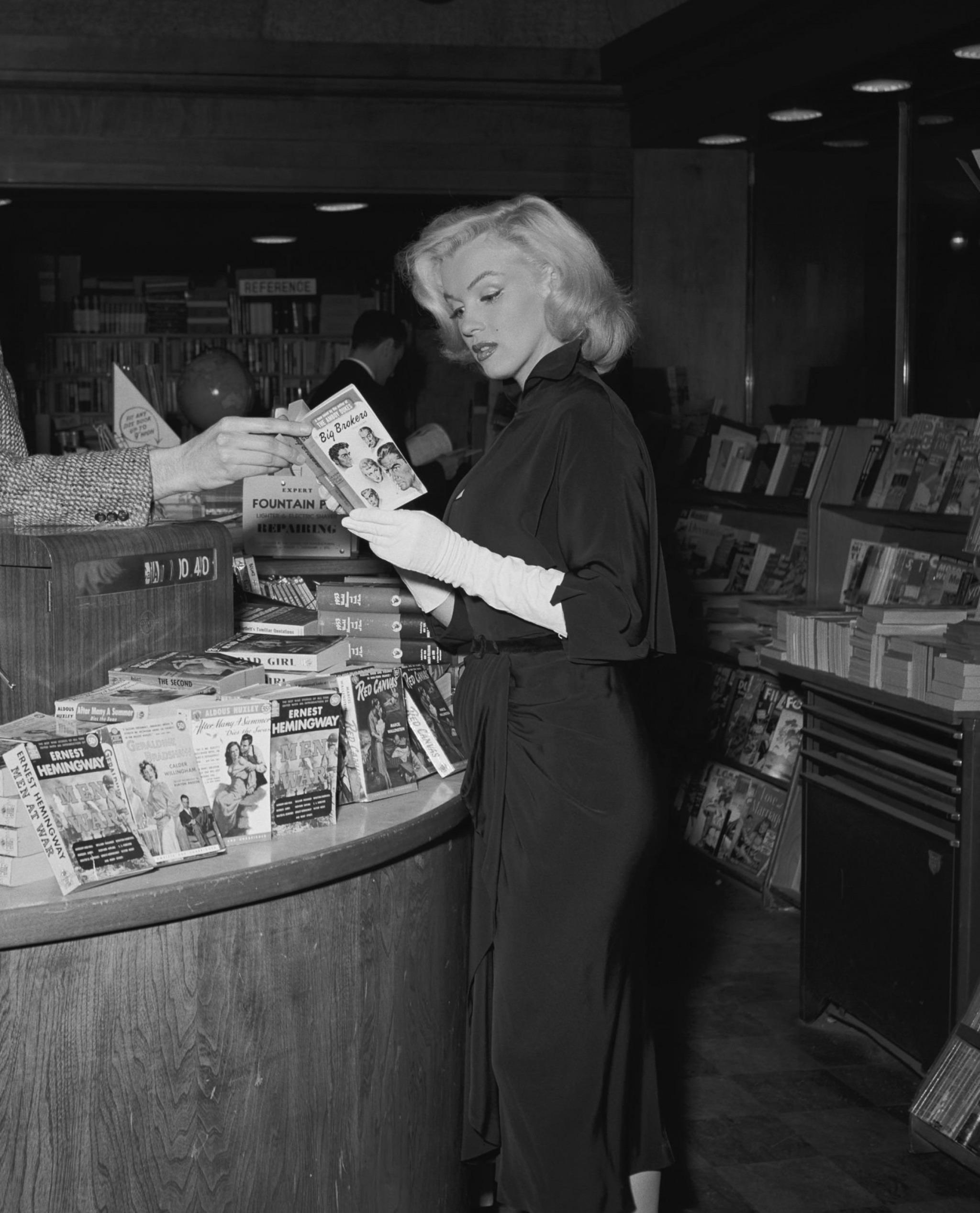 Marilyn Monroe at a bookstore on Sunset Boulevard, Beverly Hills, 1953. Photo by Andre de Dienes.jpeg