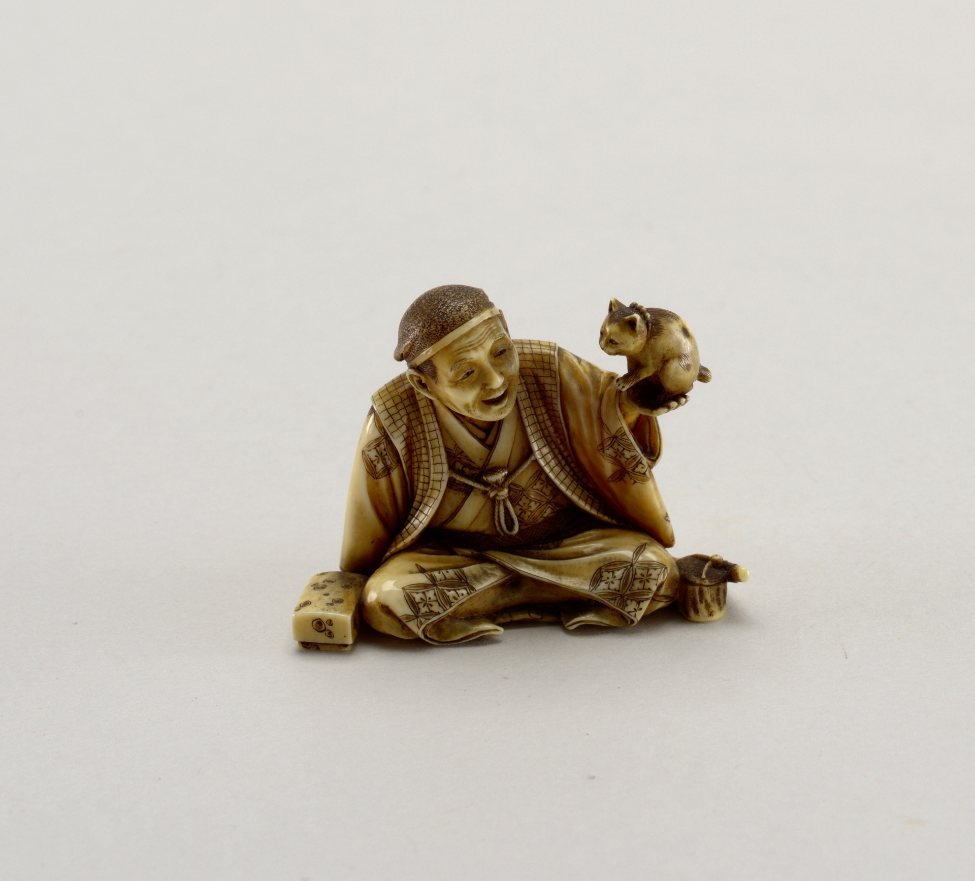 Carved ivory figurine of a man holding a cat, Chinese, c. 1800-1900.jpg