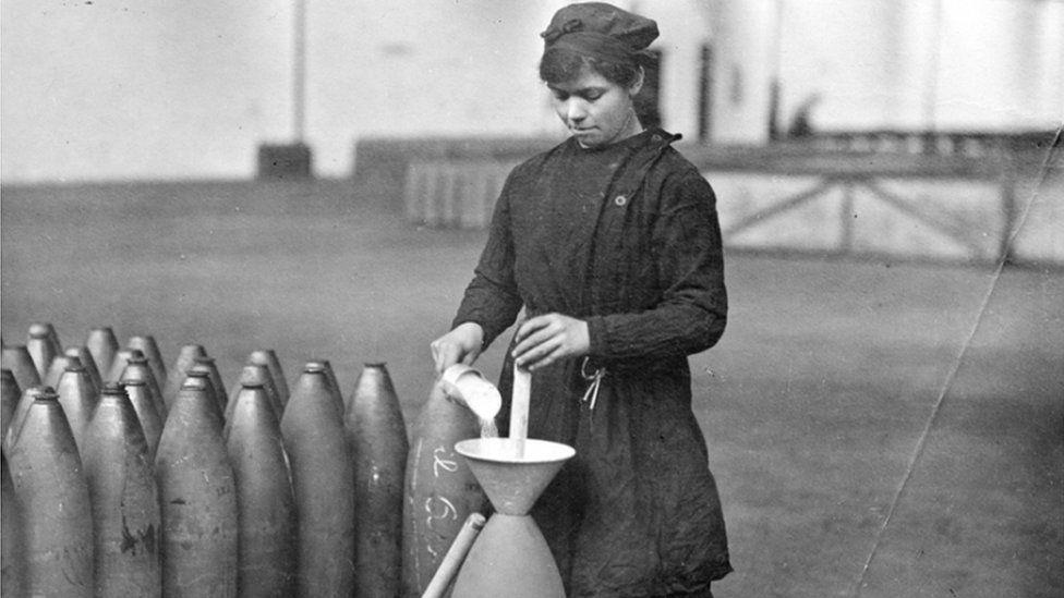 A woman filling filling shells with explosives, during world war 1 (1914-1918).jpeg