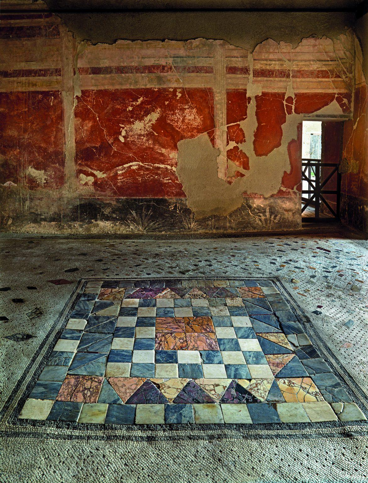 The oecus of the house of Paquius Proculus in Pompeii, Italy. In the centre of the floor of the oecus is an emblema in opus sectile of coloured marble.jpeg