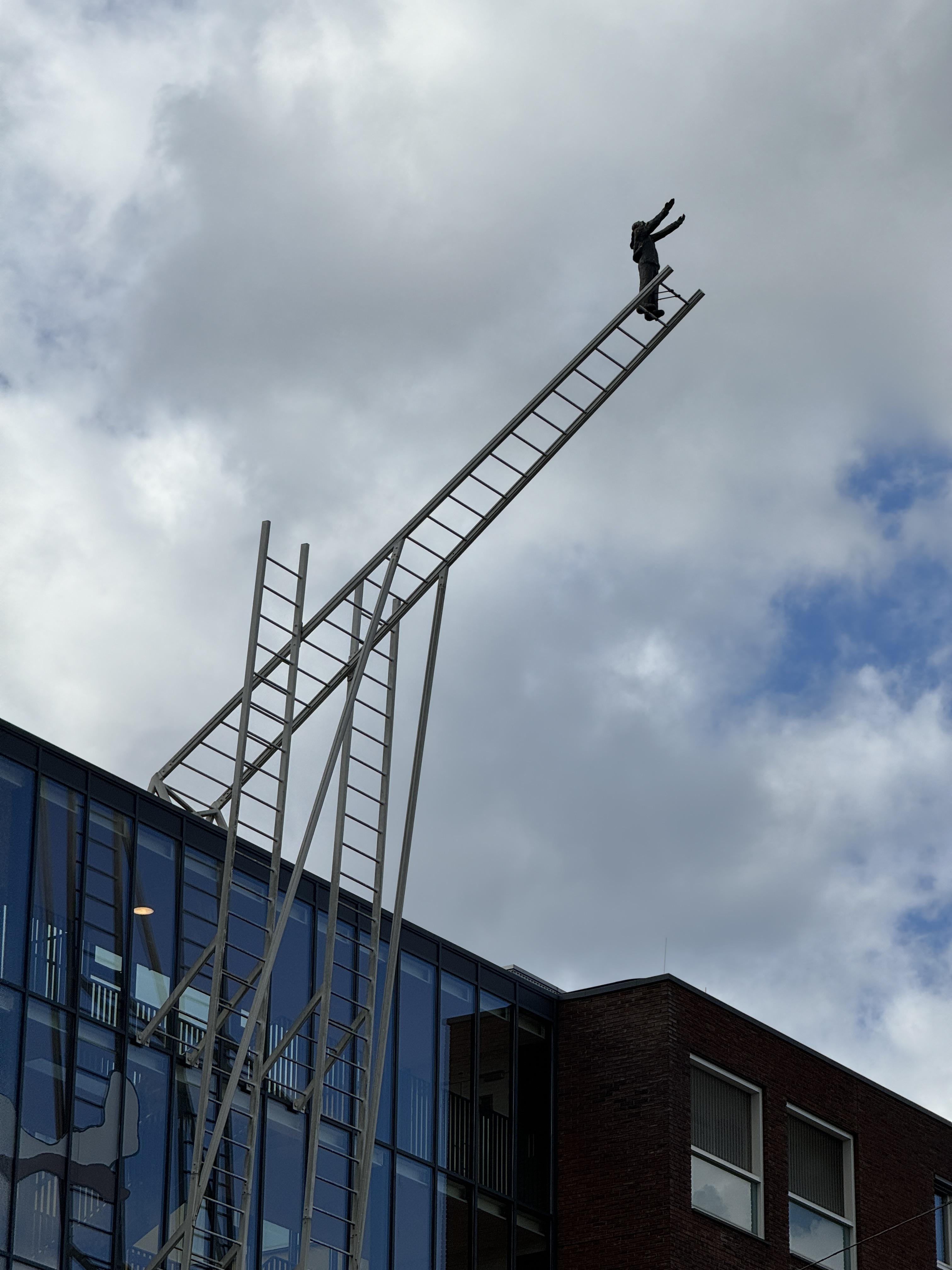 a sculpture on the side of a mental hospital.jpeg