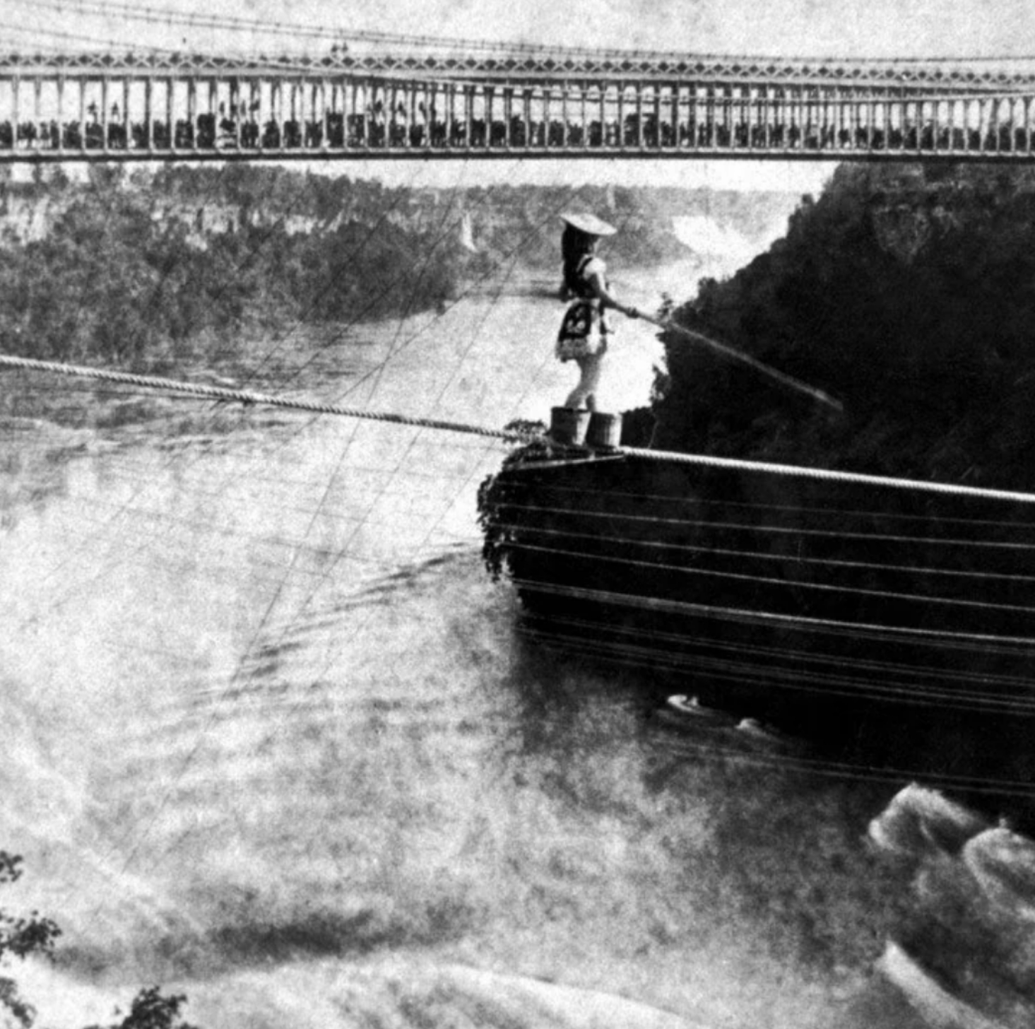 Maria Spelterini crossing the Niagara gorge on a tightrope with peach baskets on her feet in 1876.jpg