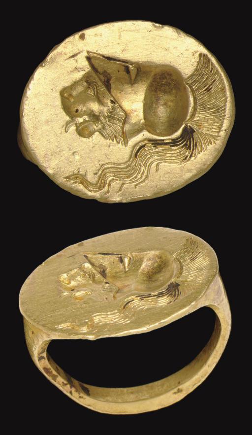 An ancient Greek gold finger ring engraved with a lion head with a lolling tongue wearing a crested Corinthian helmet. Classical Period, circa late 5th-4th century BCE, sold at Christie's in 2007.jpeg