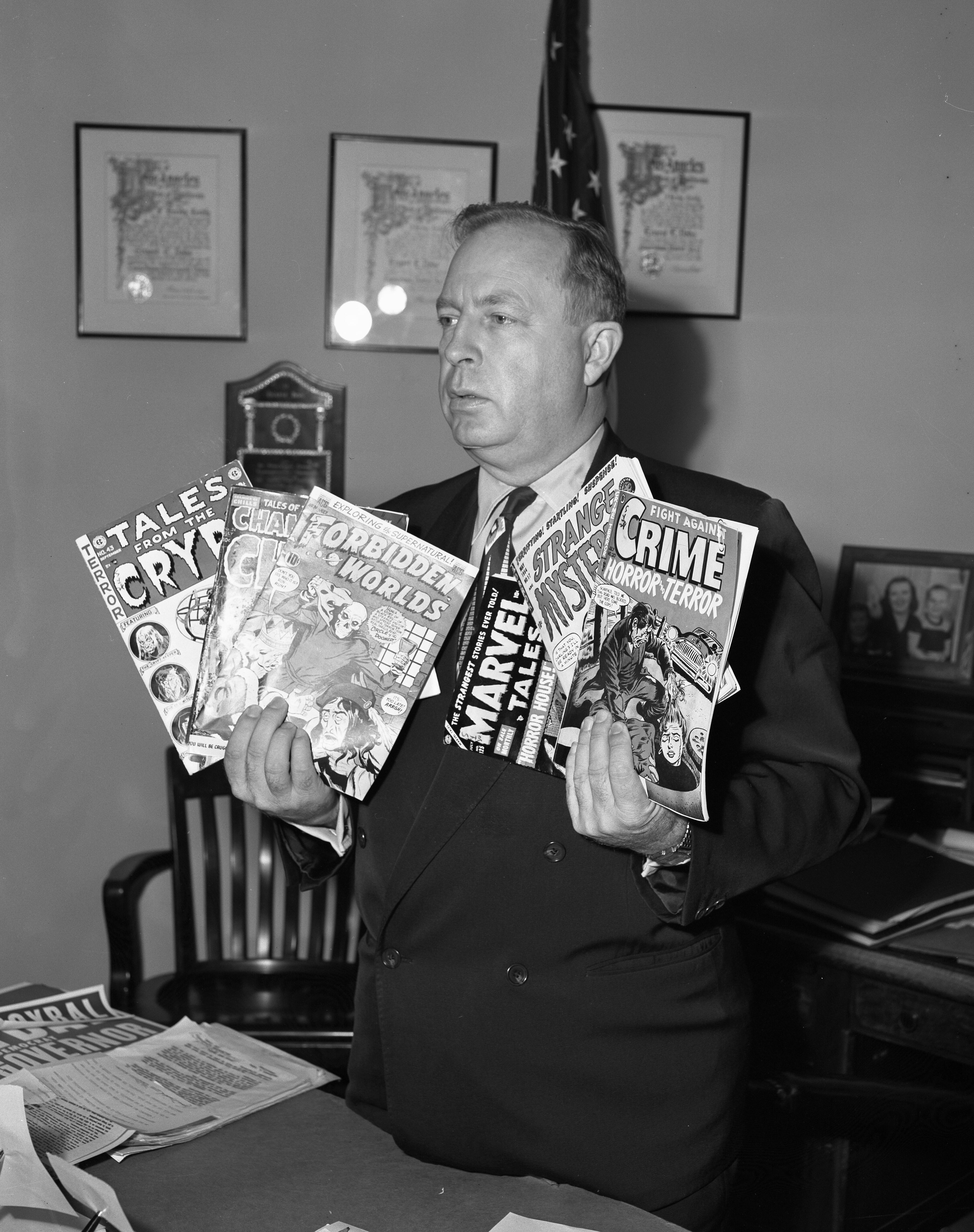 Councilman Ernest Debs with comic books (LA Daily News, 1954).jpg