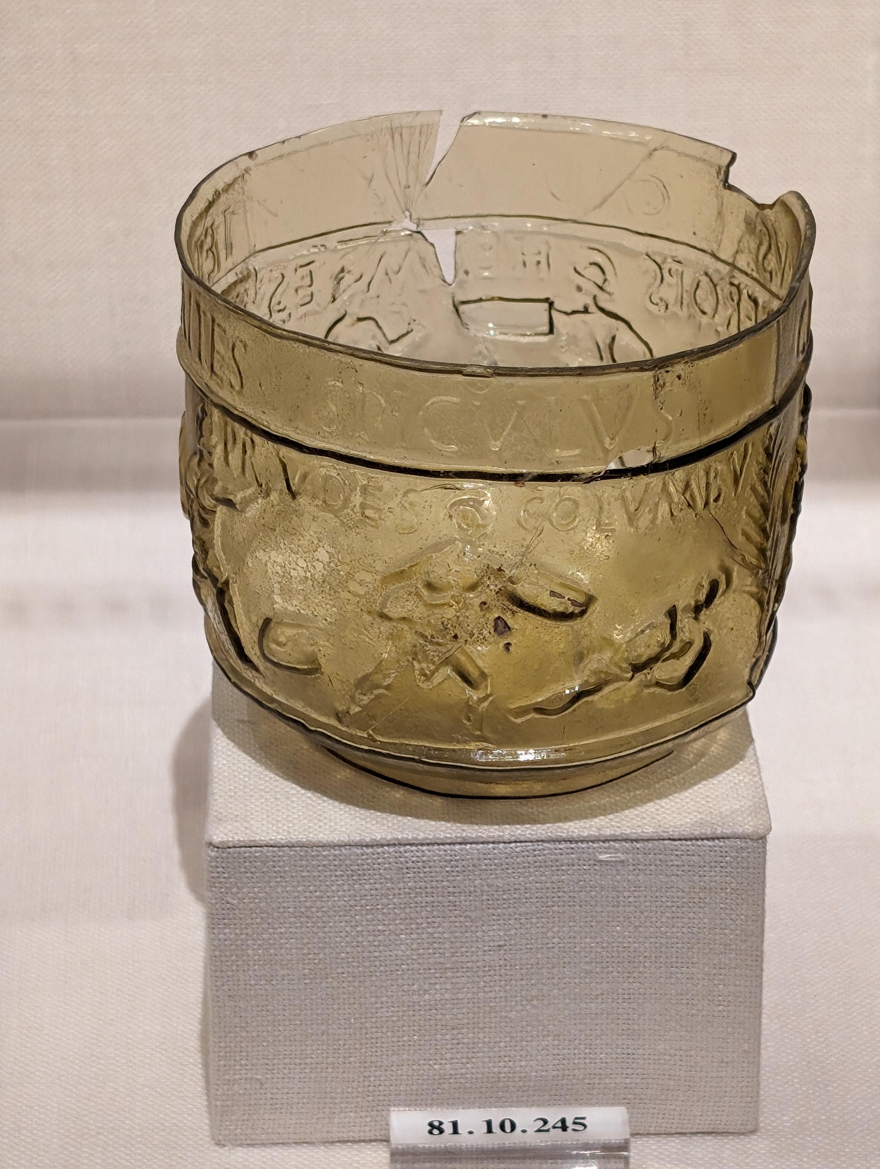 Roman glass souvenir cup bearing the images and names of gladiators popular in Rome at the time, 50-80CE.jpeg