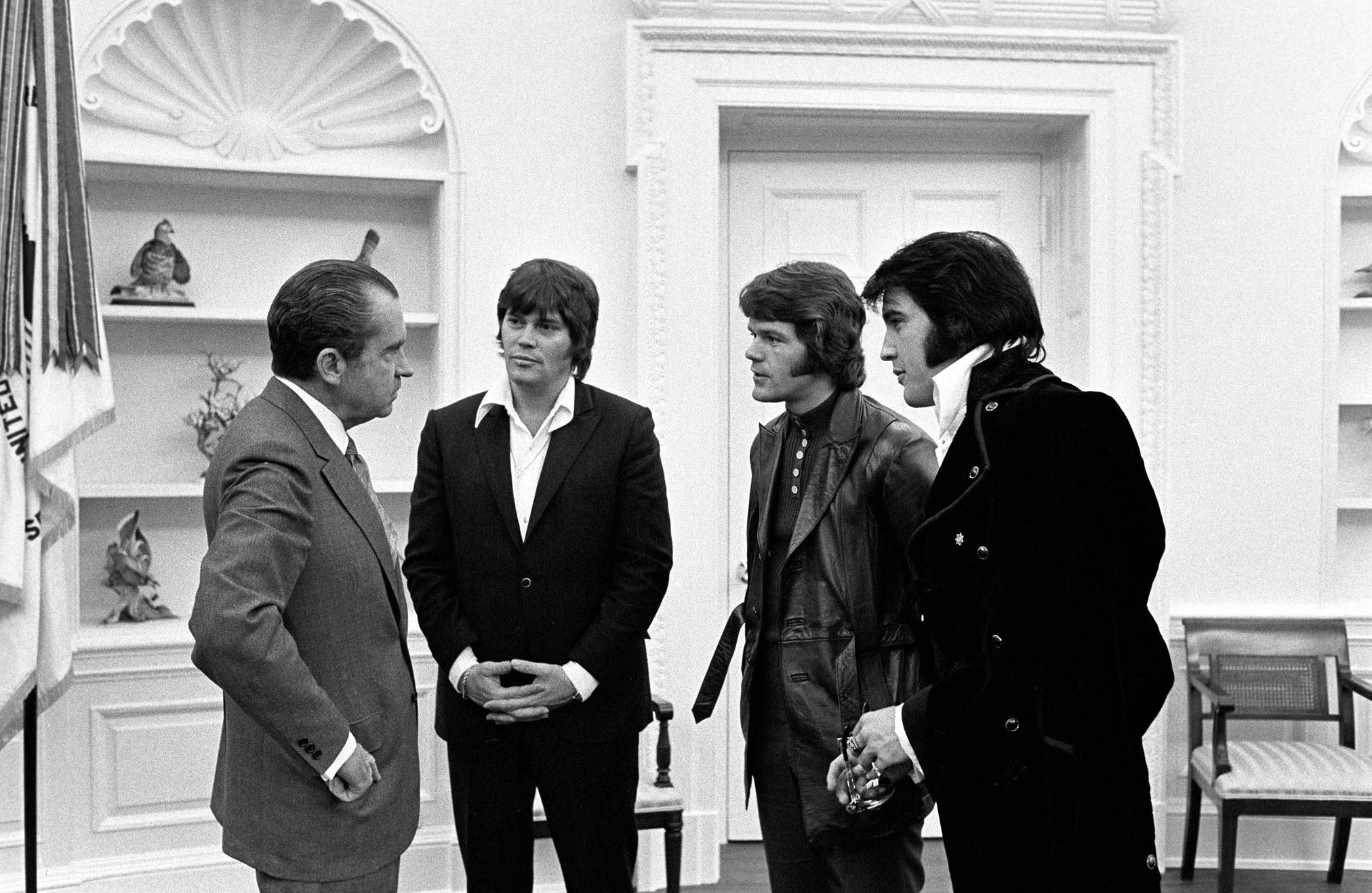 Richard Nixon meets with Elvis entourage Delbert 'Sonny' West, and Jerry Schilling, to receive a badge from the Bureau of Narcotics, 1970.jpeg