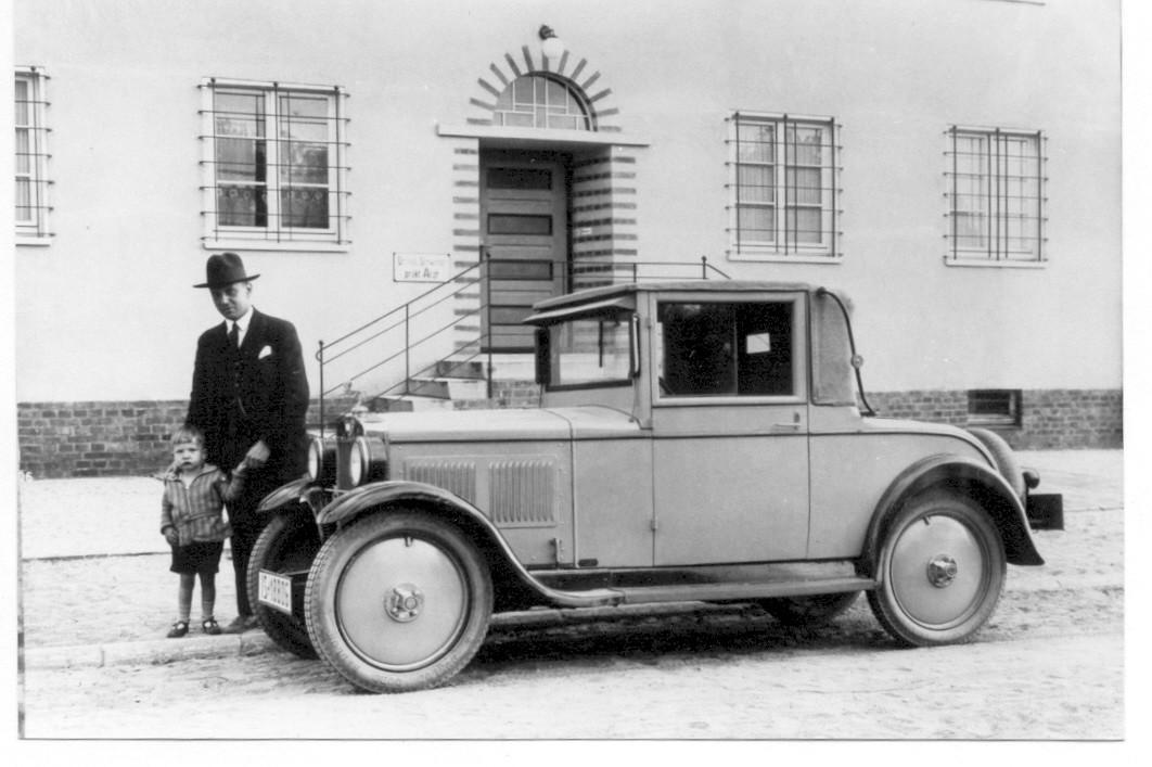 My great-uncle and his father pose with the family's first ever car, a Hanomag, presumably 1928.jpeg