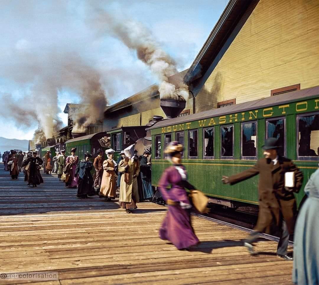 Train of the Mount Washington Cog Railway dropping off-picking passengers up at the base station in the White Mountains mountain range in New Hampshire, United States, c. 1906.jpeg