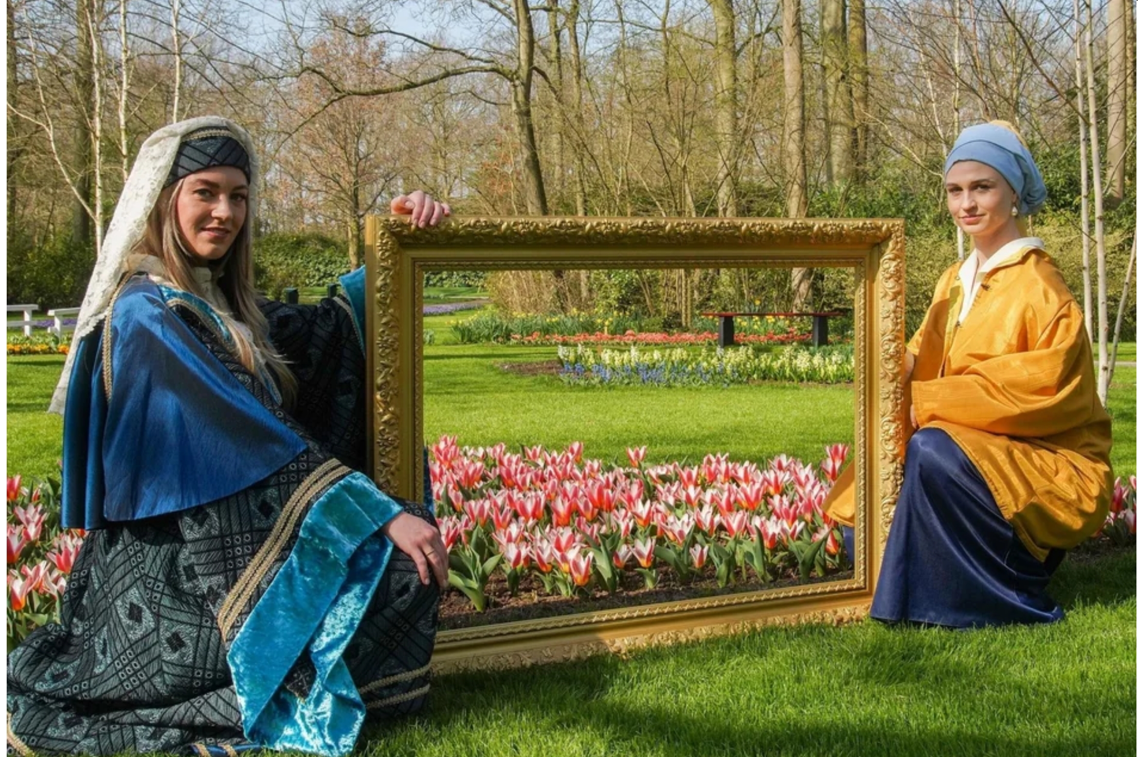 The Countess of Hainaut & Vermeers Girl with a Pearl Earring, holding a frame in floral park Keukenhof, the Netherlands.jpg