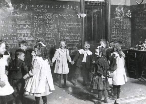 School children playing in their Iowa classroom, 1892.jpeg