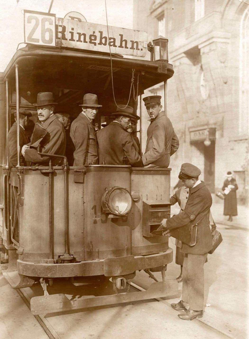 Postman empties mailbox attached to a German tram, Berlin, 1920.jpeg