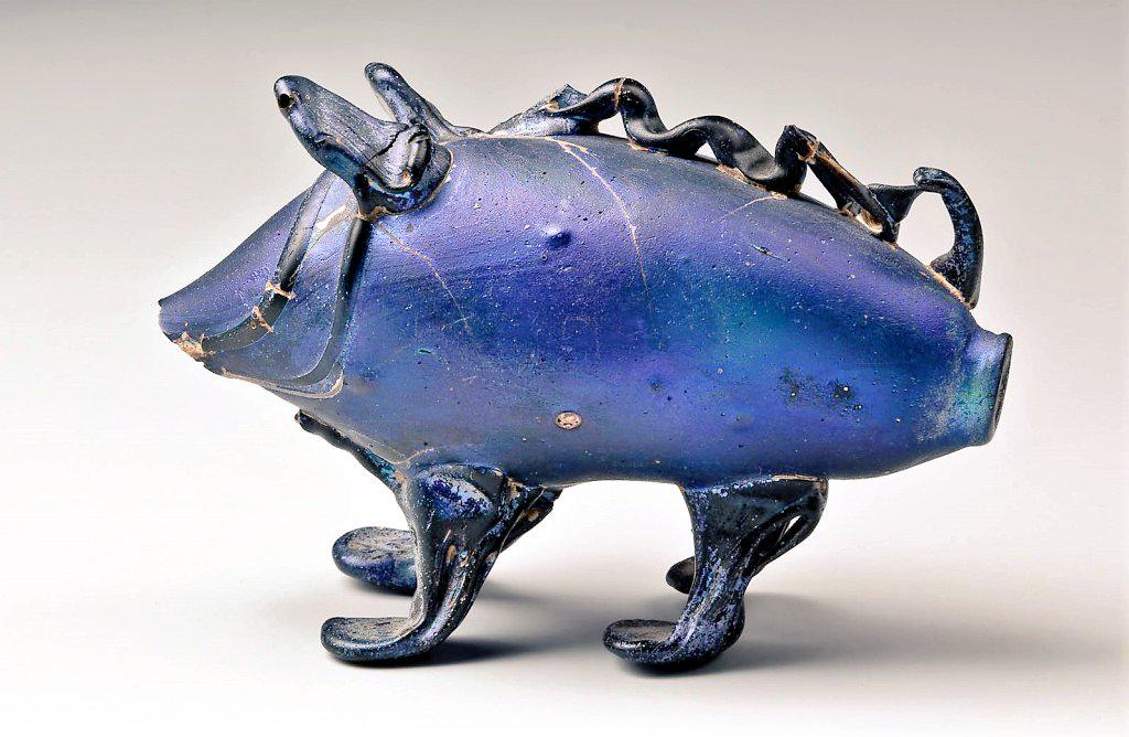 A blue glass jar in the shape of a pig, for ointment or perfume, Roman, found in a burial in Cologne. Dating late 2nd-early 3rd c. AD.jpeg