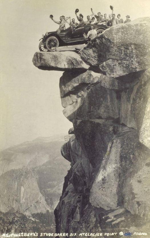Arthur Clarence Pillsbury on the hood of a Studebaker Six about a foot away from the edge at Glacier Point in Yosemite, in 1916..jpeg