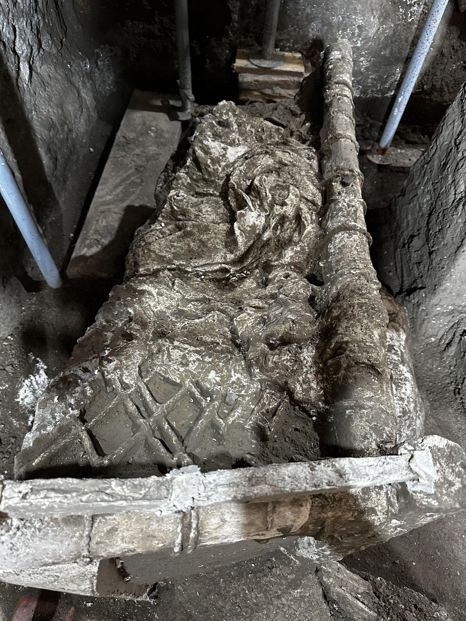 A plaster cast of a 1st century CE bed with a carelessly thrown, crumpled blanket in the slaves' room at the Villa Civita Giuliana near Pompeii, Italy.jpeg