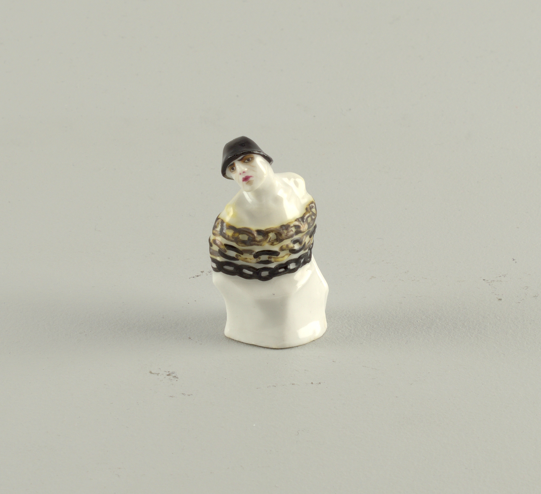 Gilt and enameled porcelain chess piece depicting a slave wearing chains made in the Soviet Union, 1922.jpg