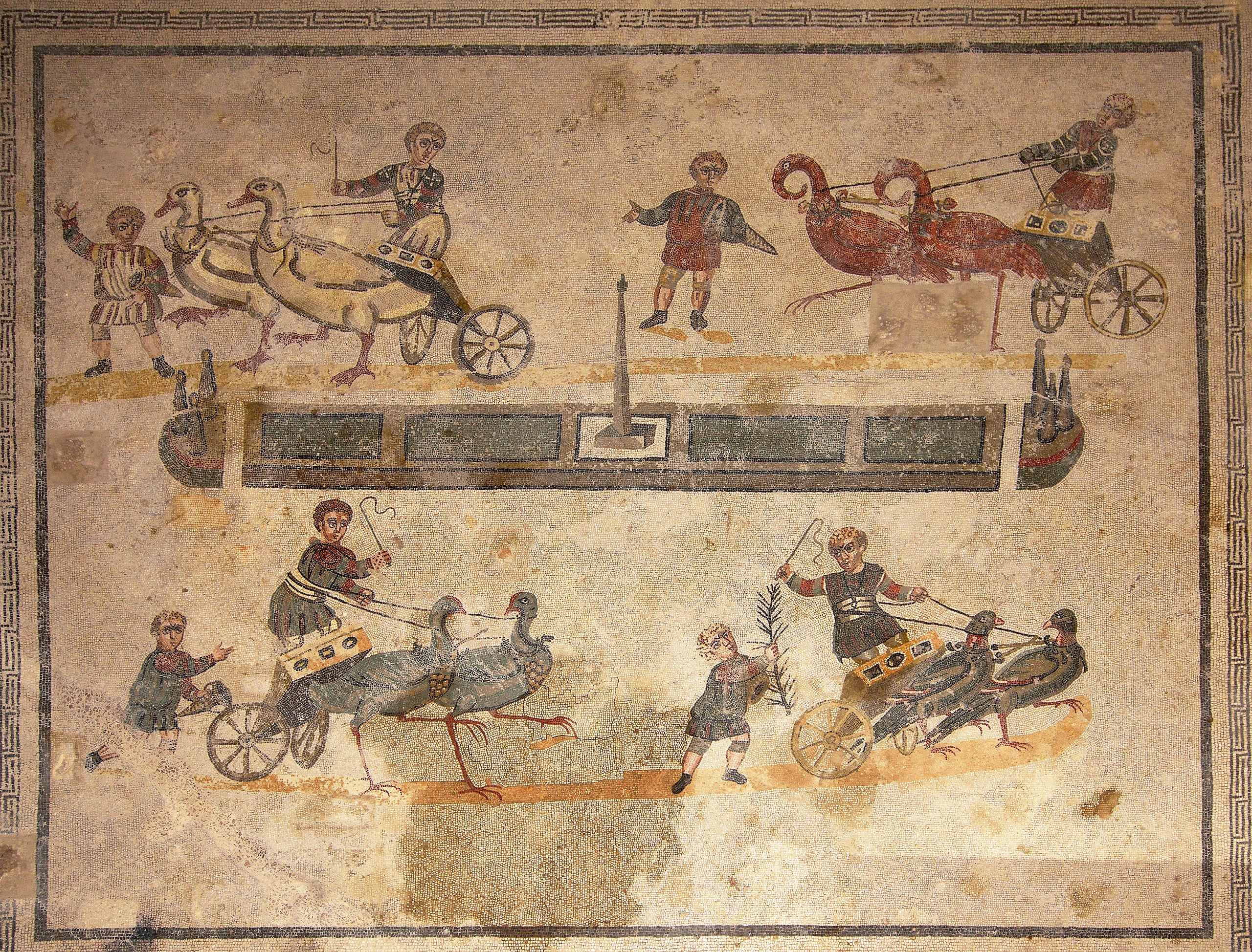 Small circus mosaic at the Villa Romana del Casale, near Piazza Armerina, Sicily, early 4th c. CE. A roman floor mosaic depicting a children's version of the circus' chariot races.jpg