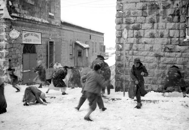 Palestinian civilians and Australian soldiers engage in a spirited snowball fight in Jerusalem. January 1942.jpeg