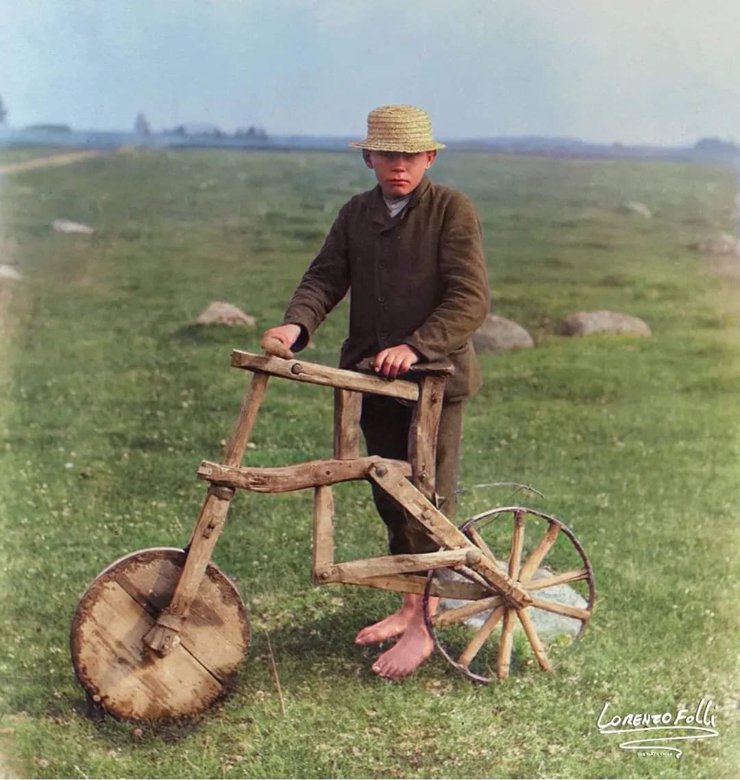 A boy from Tarvastu, Estonia, photographed with a wooden bicycle that he built. Photograph taken by Johannes Pääsuke in 1912.jpeg