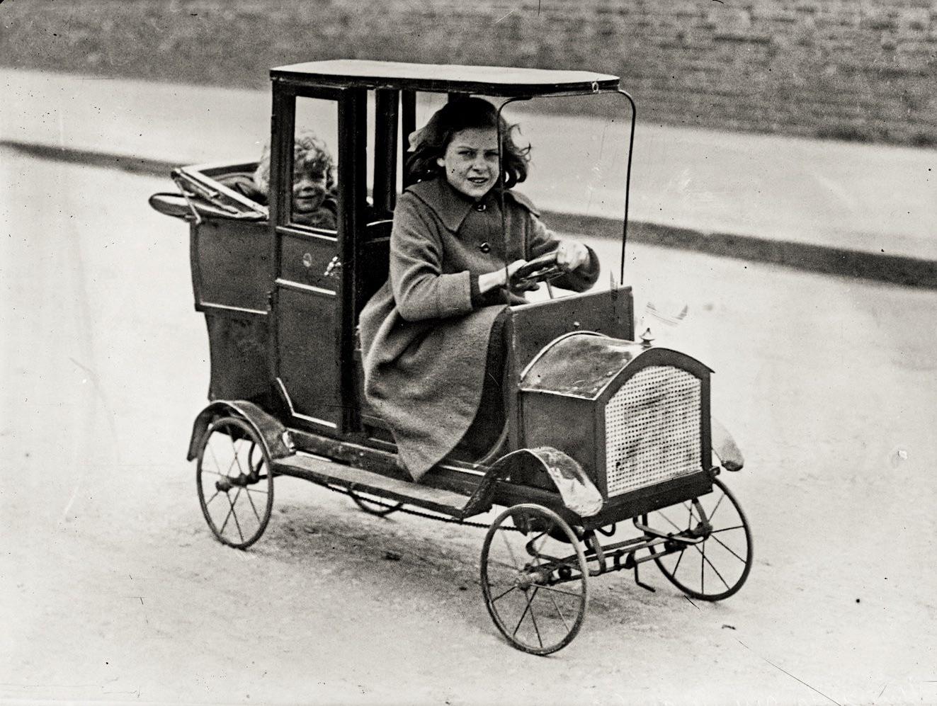 Child in her pedal car, ca. 1922.jpeg