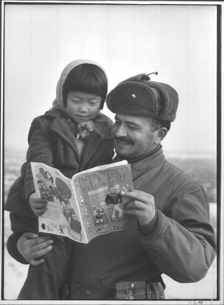 A turkish soldier looking at an american comic book with a korean girl (Korean War, 1951), photo by Carl Mydans.jpeg
