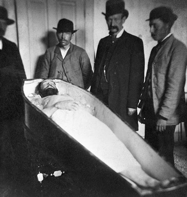 Four Men Posing With the Body of Jesse James in His Coffin in St. Joseph, Missouri, 1882.jpg
