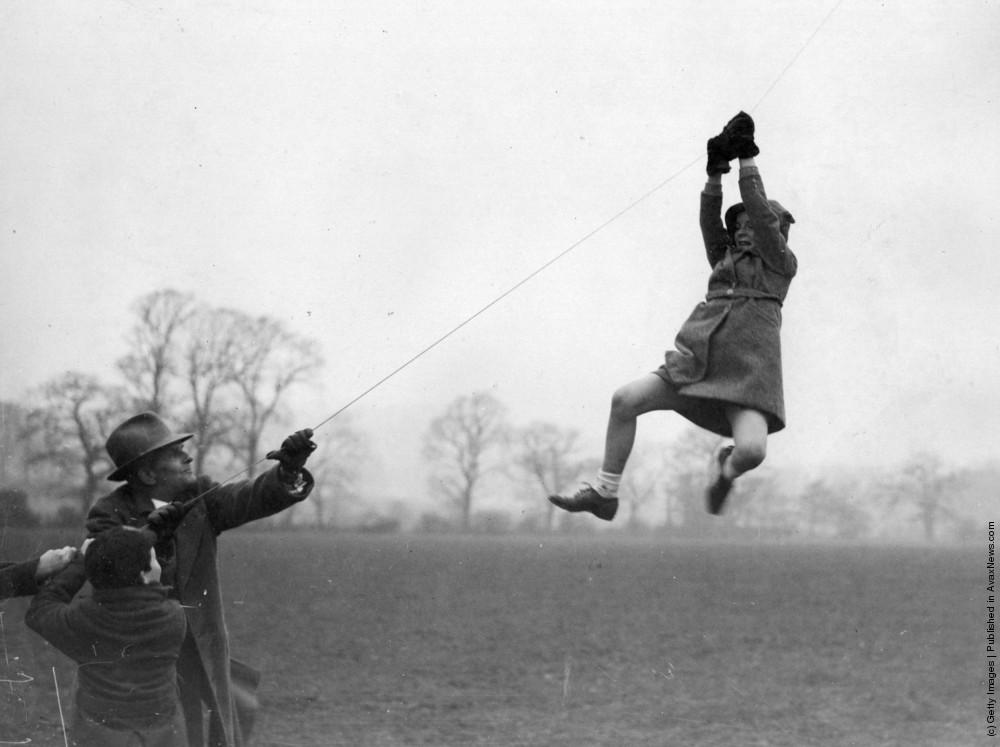 Little girl has a moment of terror when the kite she was holding was pulled to high by the wind. Circa 1940s.jpeg